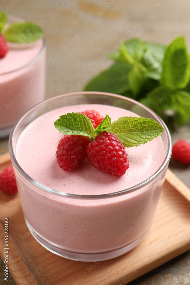 Delicious raspberry mousse with mint on wooden table Delicious raspberry mousse with mint on wooden table