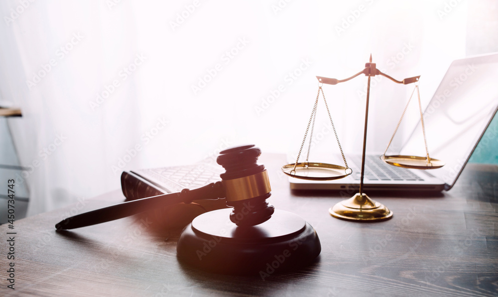 Business and lawyers discussing contract papers with brass scale on desk in office. Law, legal services, advice, justice and law concept Business and lawyers discussing contract papers with brass scale on desk in office. Law, legal services, advice, justice and law concept
