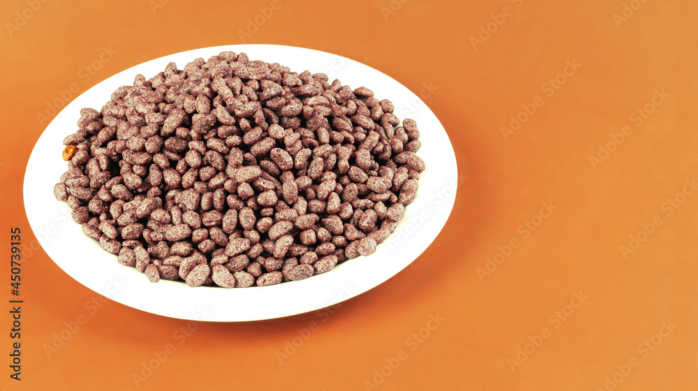 Breakfast with chocolate rice on light brown background, side view. Space for text Breakfast with chocolate rice on light brown background, side view. Space for text