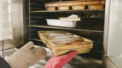 chef removing a dish from oven