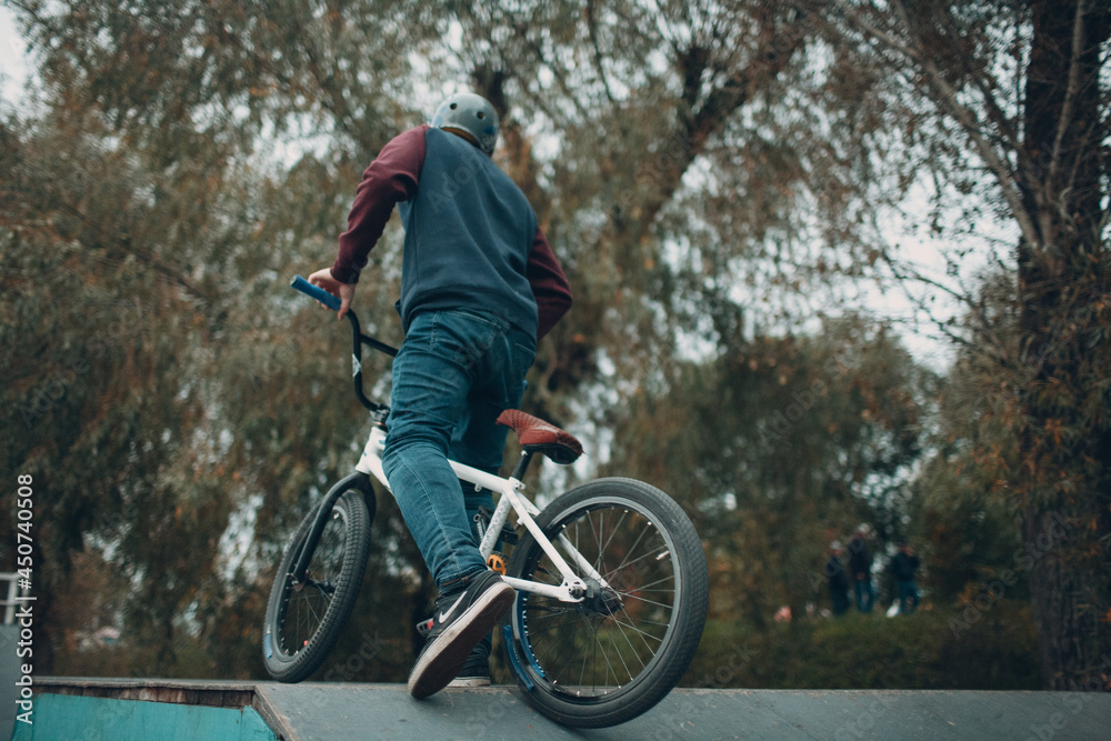 Professional young sportsman cyclist with bmx bike at skatepark Professional young sportsman cyclist with bmx bike at skatepark