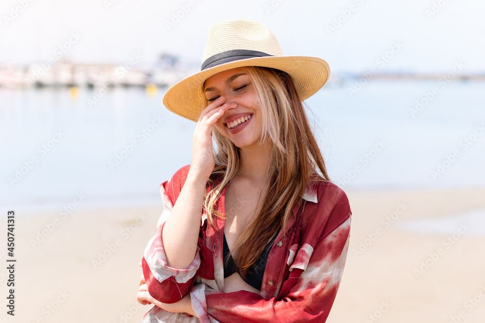 Young pretty woman in summer holidays at beach smiling a lot
