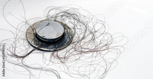 Fotografie Hair loss problem in white sink. Close-Up.