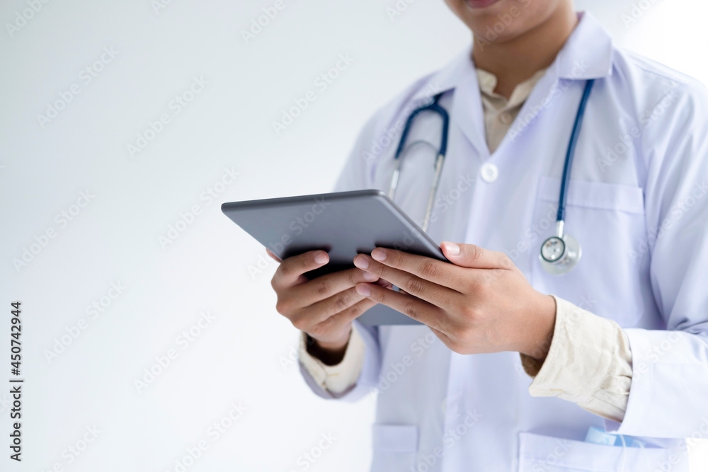 Doctor using a digital tablet computer at work. Doctor using a digital tablet computer at work.