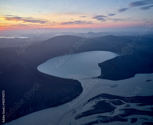 Wetland and hills against sundown sky photo