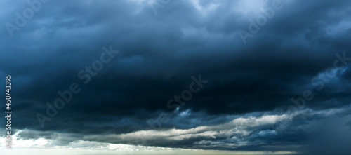 Storm sky with dark grey cumulus clouds background texture, thunderstorm