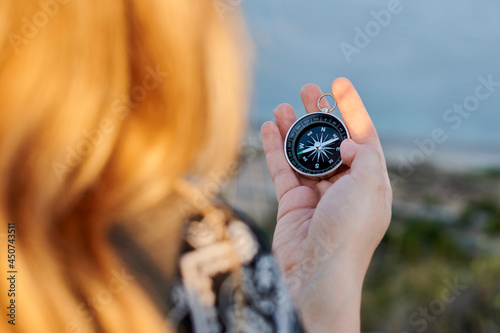 A woman's hands holding a compass