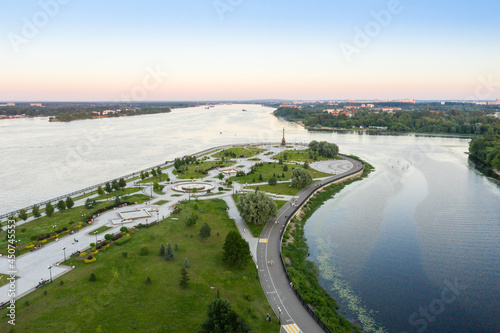 Tourist spot of Strelka Park on the Yaroslavl embankment and a view from the height of the Assumption Cathedral in Yaroslavl against the background of a summer sunset. photo