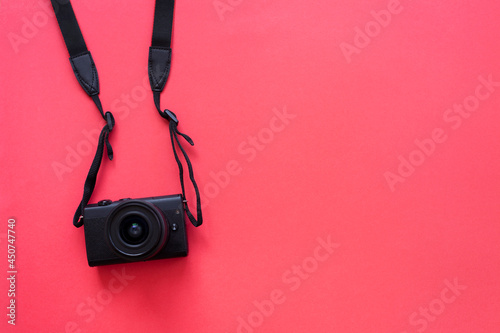 Hanging camera flat on red background