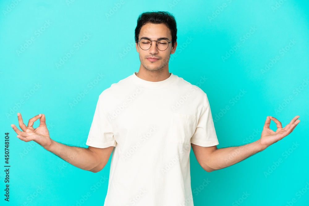 Caucasian handsome man over isolated blue background in zen pose Caucasian handsome man over isolated blue background in zen pose