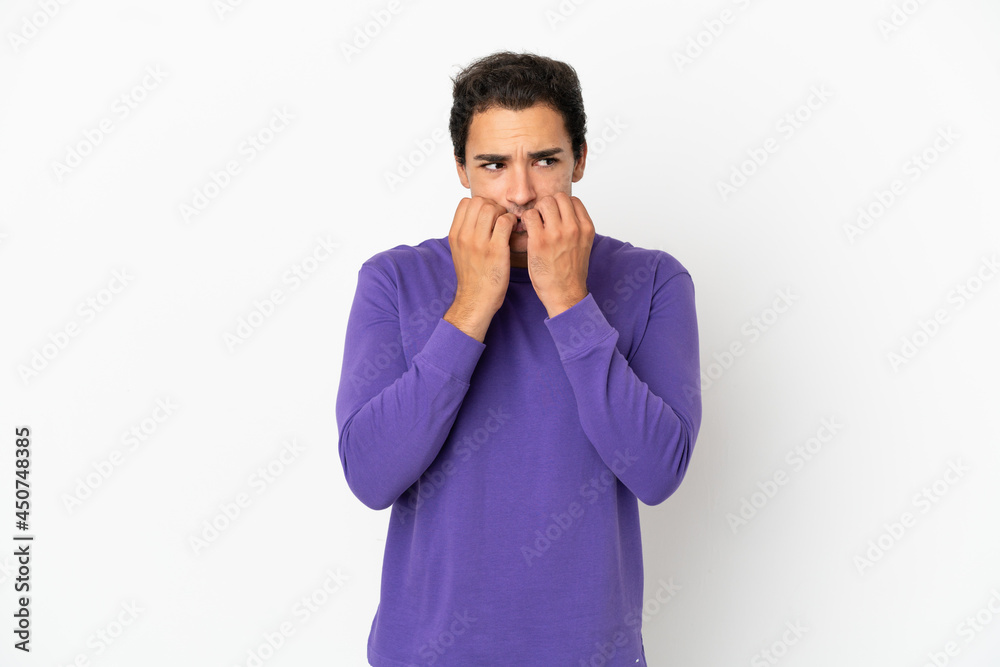 Caucasian handsome man over isolated white background nervous and scared putting hands to mouth Caucasian handsome man over isolated white background nervous and scared putting hands to mouth