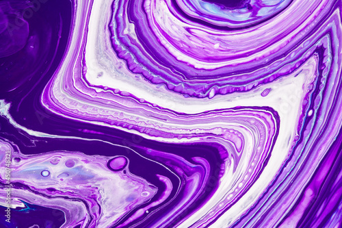 Fluid art texture. Backdrop with abstract iridescent paint effect. Liquid acrylic picture with flows and splashes. Mixed paints for interior poster. Purple, blue and white overflowing colors.