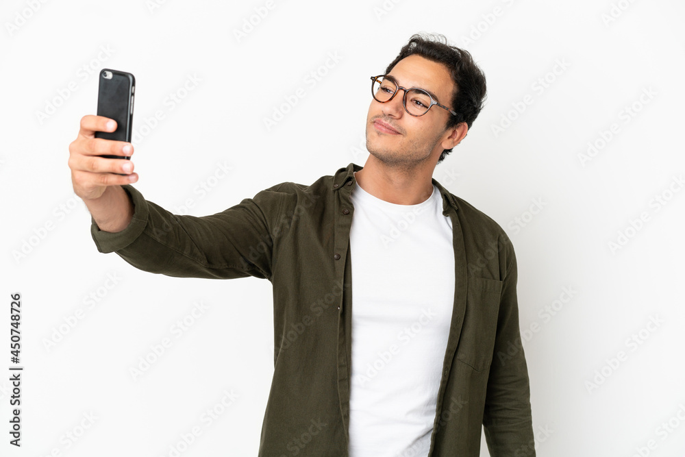 Caucasian handsome man over isolated white background making a selfie Caucasian handsome man over isolated white background making a selfie