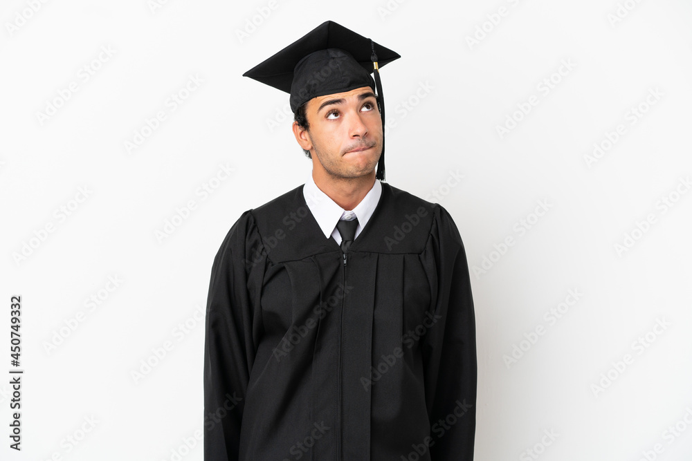 Young university graduate over isolated white background and looking up Young university graduate over isolated white background and looking up