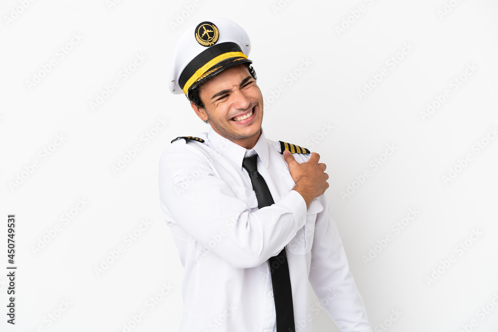 Airplane pilot over isolated white background suffering from pain in shoulder for having made an effort Airplane pilot over isolated white background suffering from pain in shoulder for having made an effort