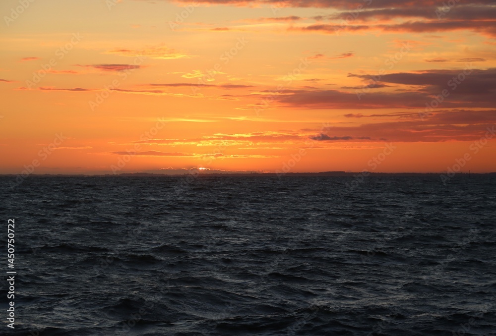 sunset over the sea with orange sky 