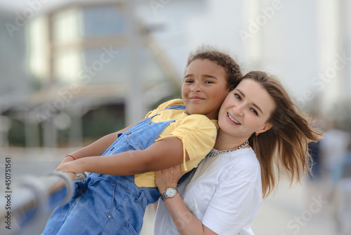 Good-looking happy young woman spending time with daughter.