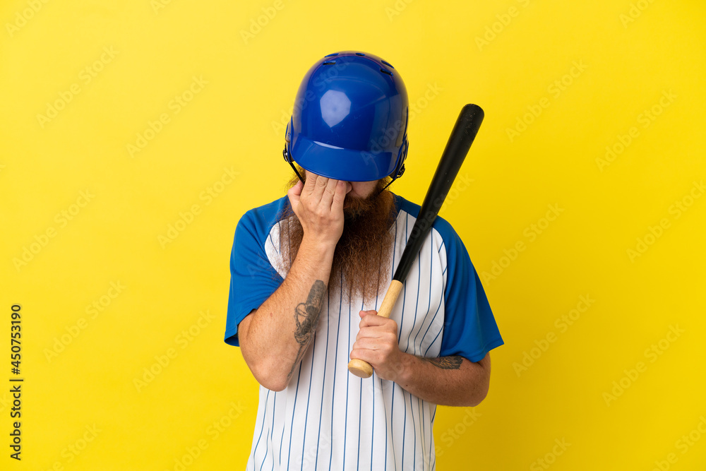Redhead baseball player man with helmet and bat isolated on yellow background with tired and sick expression