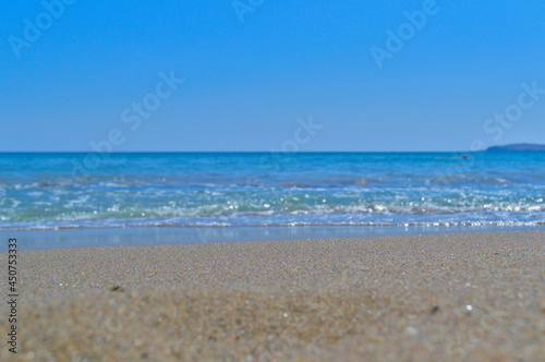 Blue sea and sandy beach as a blurry background for text. photo