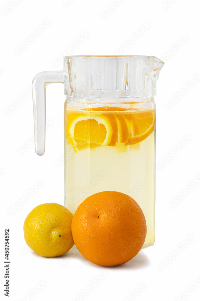 Isolated on a white background is a jug with homemade lemonade, an orange and a lemon. Isolated on a white background is a jug with homemade lemonade, an orange and a lemon.