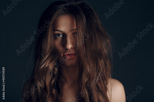 Portrait of beautiful young brunette woman with healthy hair. © primipil