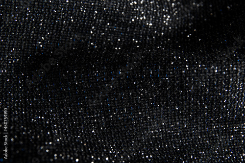 Fabric evening black dress girl with sequins, rhinestones. colorful sequined texture