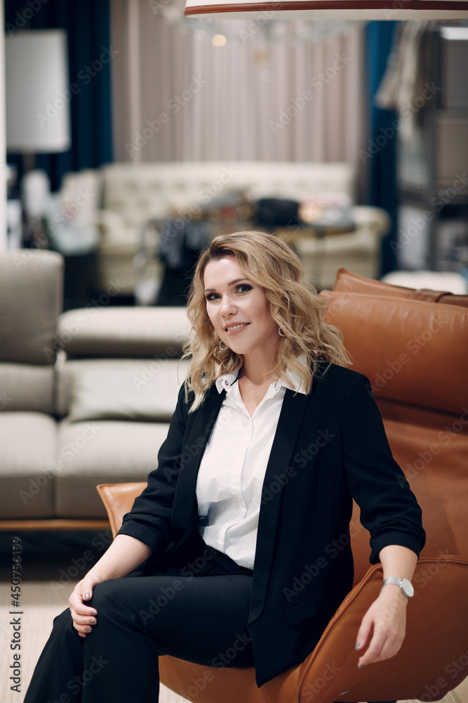 Happy adult woman relaxing indoor on her couch at home. Happy adult woman relaxing indoor on her couch at home.