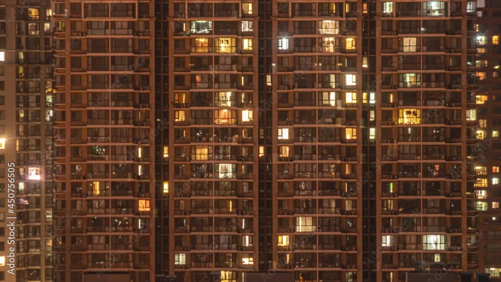 Closeup of apartment building in Beijing timelapse. Chinese crowded city with lights turning from evening to morning. Fast paced modern Asian night-scape time lapse in urban metropolis. Closeup of apartment building in Beijing timelapse. Chinese crowded city with lights turning from evening to morning. Fast paced modern Asian night-scape time lapse in urban metropolis.