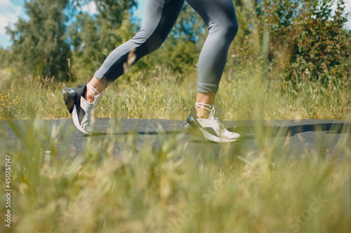 Runner woman in running shoes closeup of woman sporty legs. Female jogging