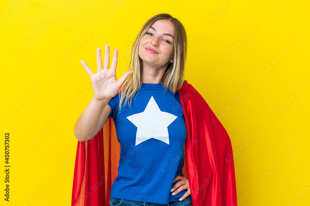 Super Hero Romanian woman isolated on yellow background counting five with fingers