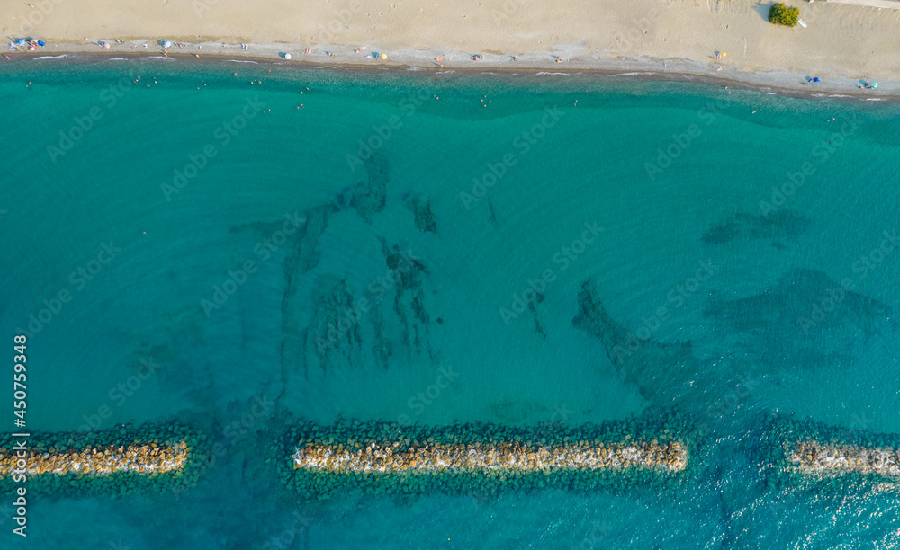 Aerial view from flying drone of people relaxing on the beach. Paphos Cyprus