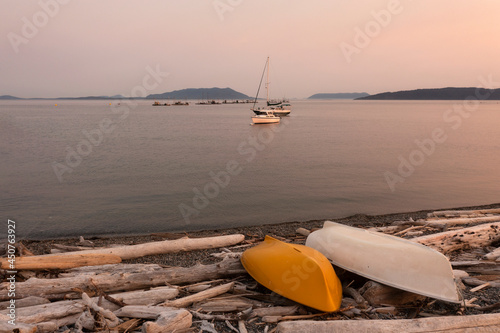 Boats Anchored in the San Juan Islands During a Beautiful Sunset. With reefnet salmon fishing boats in the background two pleasure boats anchor in Legoe Bay just off the Lummi Island coastline. photo