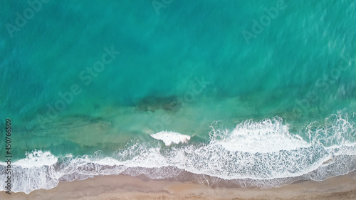 Aerial from drone of an stunning beautiful sea landscape beach with turquoise water at sunrise. Free copy space.