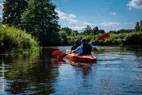 people kayaking on the Narew river in Podlasie, father and son, joint activity, two people, group rafting