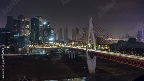 Chongqing bridge to Qiba downtown area night timelapse. Evening time lapse of busy metropolitan highway overpass in city center of busy Chinese city. photo