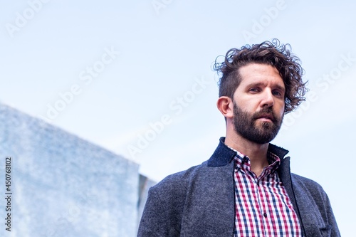Model man looking serious at the camera with background for copyspace.