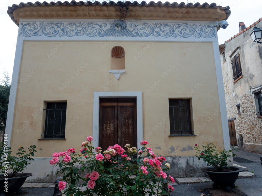 ancient church facade with frescoes in  a small village in the French Riviera back country