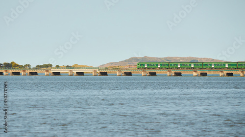 View from sea on the Malahide Bridge, railroad bridge with Dart train passing.