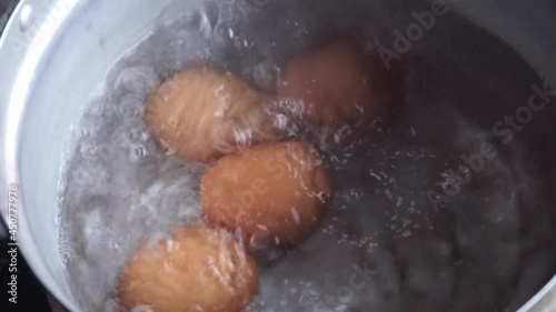 Chicken eggs are boiled in a saucepan
