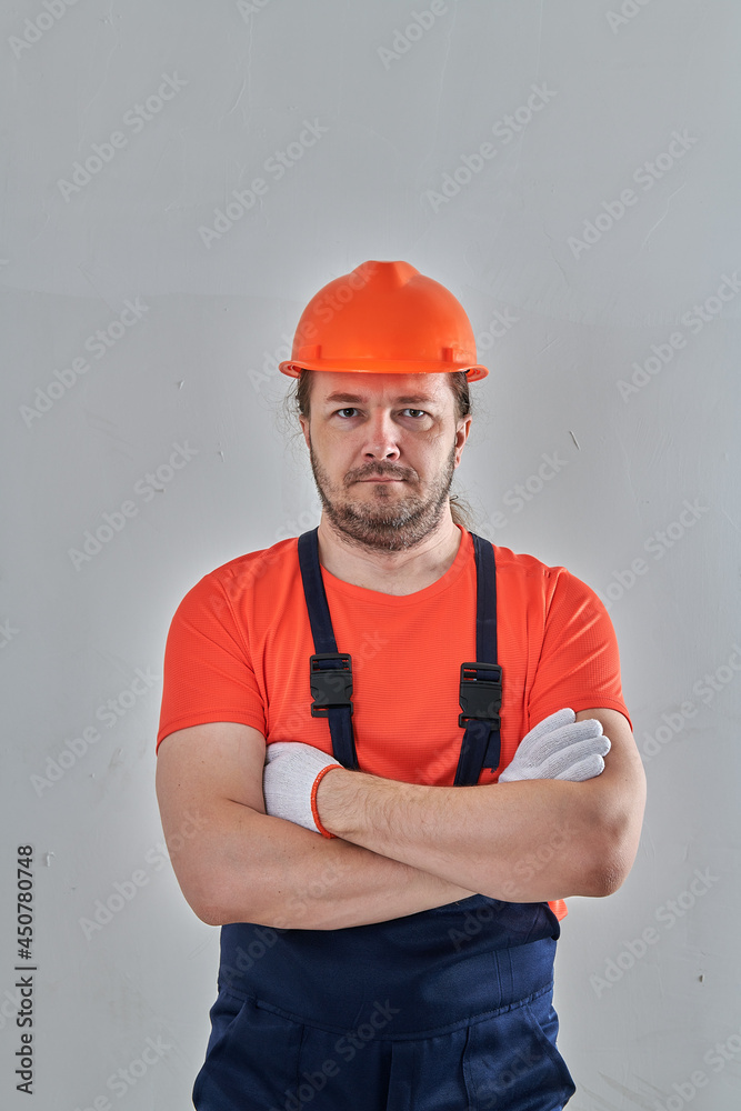 a serious worker in special clothes stands