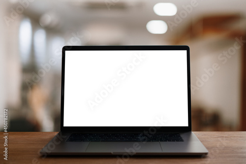 laptop with screen on wood table.