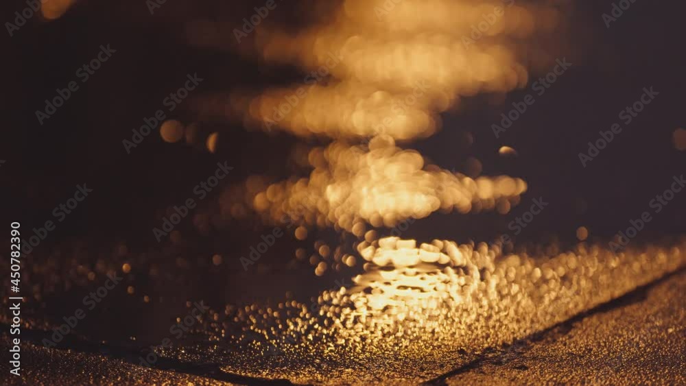 Rainy night, urban city evening, a sprinkling of rain drops, streetlights reflecting in dark puddles, dripping water droplets (4)