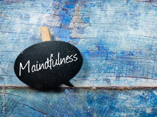 Text Maindfulness writing on wooden board on a blue wooden background. Trending photos concept. photo