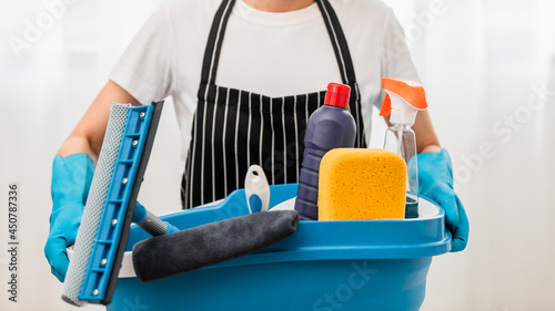 Close up, Housekeeper wearing protective gloves holding a bucket with set cleaning equipment, Cleaner Services, Disinfection and Hygiene Concept.