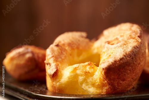 Fresh cooked yorkshire puddings on a  wooden background. photo