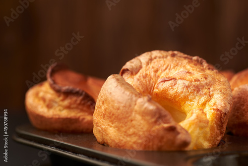 Fresh cooked yorkshire puddings on a  wooden background. photo