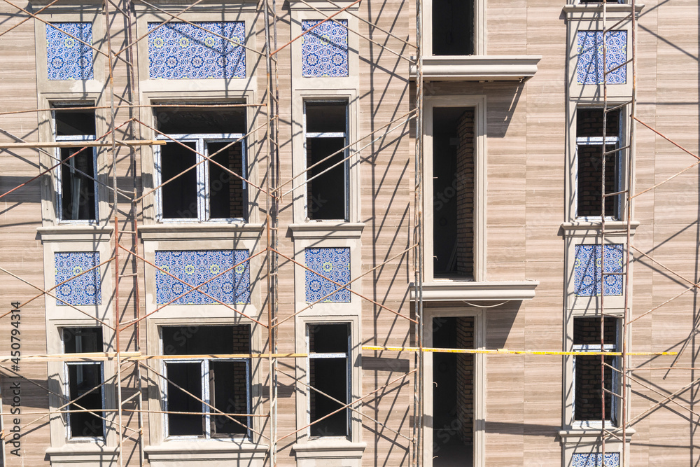 Finishing works on the facade of a new residential buildings