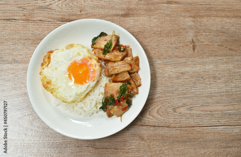 spicy stir fried slice grilled pork with chili and basil leaf topping egg on dish spicy stir fried slice grilled pork with chili and basil leaf topping egg on dish