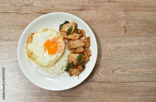 spicy stir fried slice grilled pork with chili and basil leaf topping egg on dish