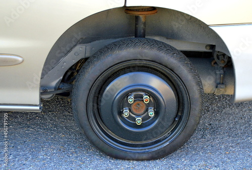 Space saver tire on a car.